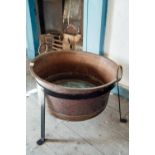 19th. C. hand beaten copper log bucket raised on metal stand. { 59cm H X 95cm W}.