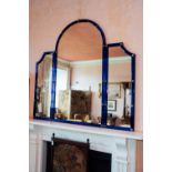 19th. C. overmantle mirror with arched top and mounted in a blue glass frame in the Irish Georgian