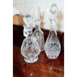 Three cut glass decanters.