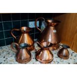 Set of five 19th. C. graduating copper haystack measures.