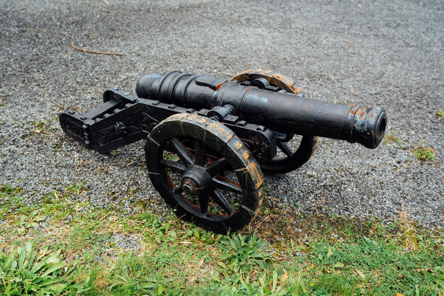 Pair of cast iron cannons. { 55cm H X 50 cm W X106 cm D }.