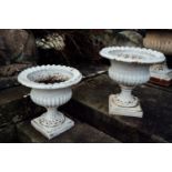 Pair of 19th C. cast iron urns on reeded columns and platform base. { 38 cm H X 38cm D }.