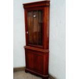 Mahogany corner cupboard the glazed door above a panelled door. { 189 cm H X 82cm W }.