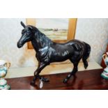 Bronze model of a horse. { 54cm H X 67cm W }.