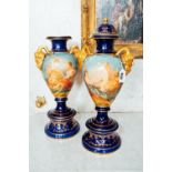 Pair of Bristol blue ceramic lidded vases with painted panel and gilded mounts { 58cm H }.