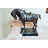 Bronze model of a horse mounted on a marble base. { 25cm H X 26cm W }.