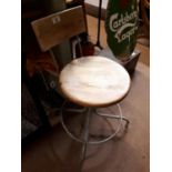 Industrial revolving metal stool with wooden seat.