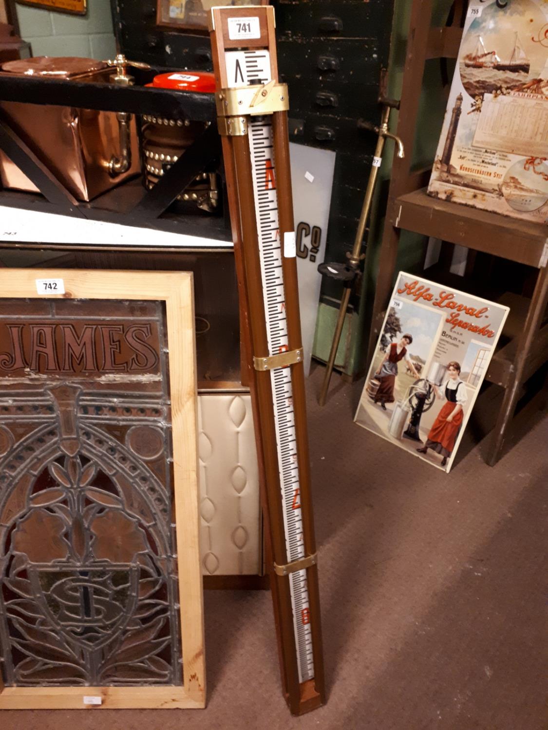 Mahogany and brass measuring stick {139 cm H}.