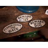 Three vintage cast iron signs.