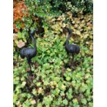 Pair of cast iron models of storks. { 102cm H }.