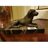 Bronze model of a Seated Dog mounted on a marble base. { 15cm H X 22cm W X 9cm D }.