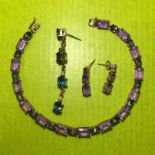 UNMARKED YELLOW METAL AMETHYST AND STONE SET TENNIS BRACELET 8.