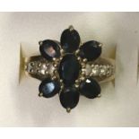 LADIES 9CT GOLD SAPPHIRE AND CZ FLOWER HEAD RING 4.