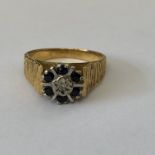 18CT YELLOW GOLD SAPPHIRE AND DIAMOND CHIP RING WITH TEXTURED SHOULDERS 5.