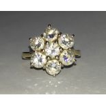 18CT GOLD AND DIAMOND MOUNTED CIRCULAR CLUSTER RING WITH SEVEN STONES EACH APPROXIMATELY 0.