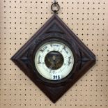 ANEROID BAROMETER IN CARVED LOZENGE SHAPED PANEL