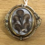 VICTORIAN PINCHBECK MOURNING BROOCH WITH REVERSIBLE CENTRE CONTAINING LOCKET OF HAIR