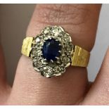 18CT GOLD SAPPHIRE AND DIAMOND CLUSTER RING WITH A LATER MOUNT 4.