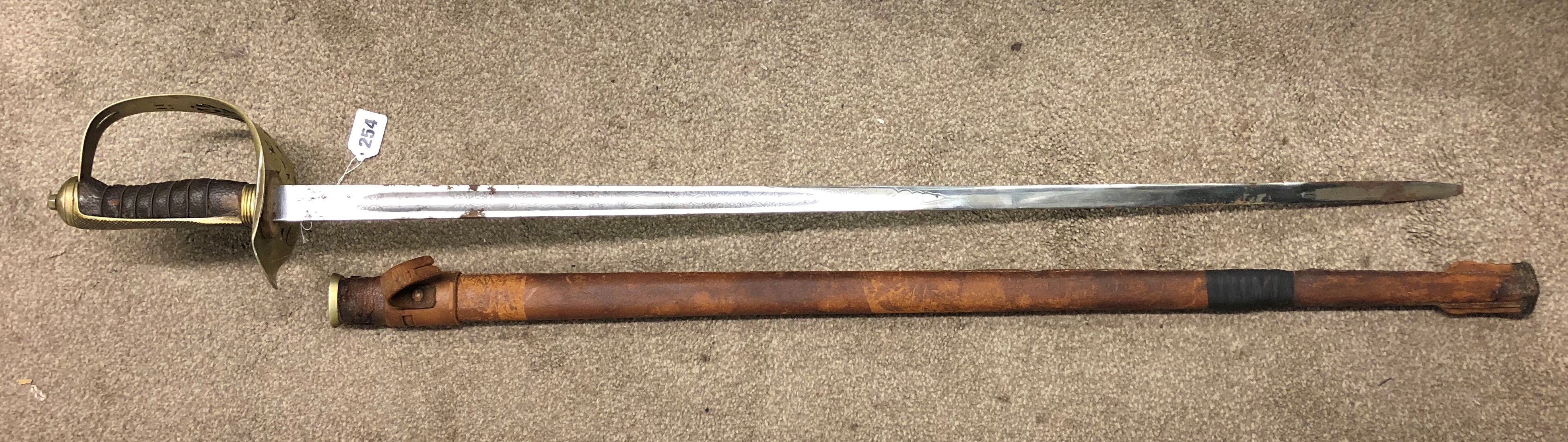 MID 20TH CENTURY ETCHED BLADED DRESS SWORD WITH BASKET HILT IN A LEATHER SCABBARD (BLADE - 85CM L)