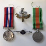 TWO WWII MEDALS - DEFENCE AND SERVICE AND RELATED MILITARY BADGES