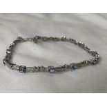 STAMPED 10K WHITE GOLD AND TANZANITE TENNIS BRACELET 6.