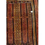 MID 20TH CENTURY RUG WITH GEOMETRIC PATTERN ON A DARK RED AND BLUE GROUND 99CM X 135CM APPROX