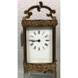 19TH CENTURY BRASS CARRIAGE CLOCK IN ORNATE CASE SHAPED TRAVELLING HANDLE WITH KEY 12CM H APPROX