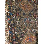 EARLY 20TH CENTURY CAUCASIAN RUG ON A MAINLY BLUE GROUND DECORATED WITH ANIMAL FIGURES AND SYMBOLS