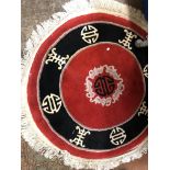 TWO LATE 20TH CENTURY CHINESE RUGS ON RED AND BLACK GROUND, SHOWING CHINESE SYMBOLS,