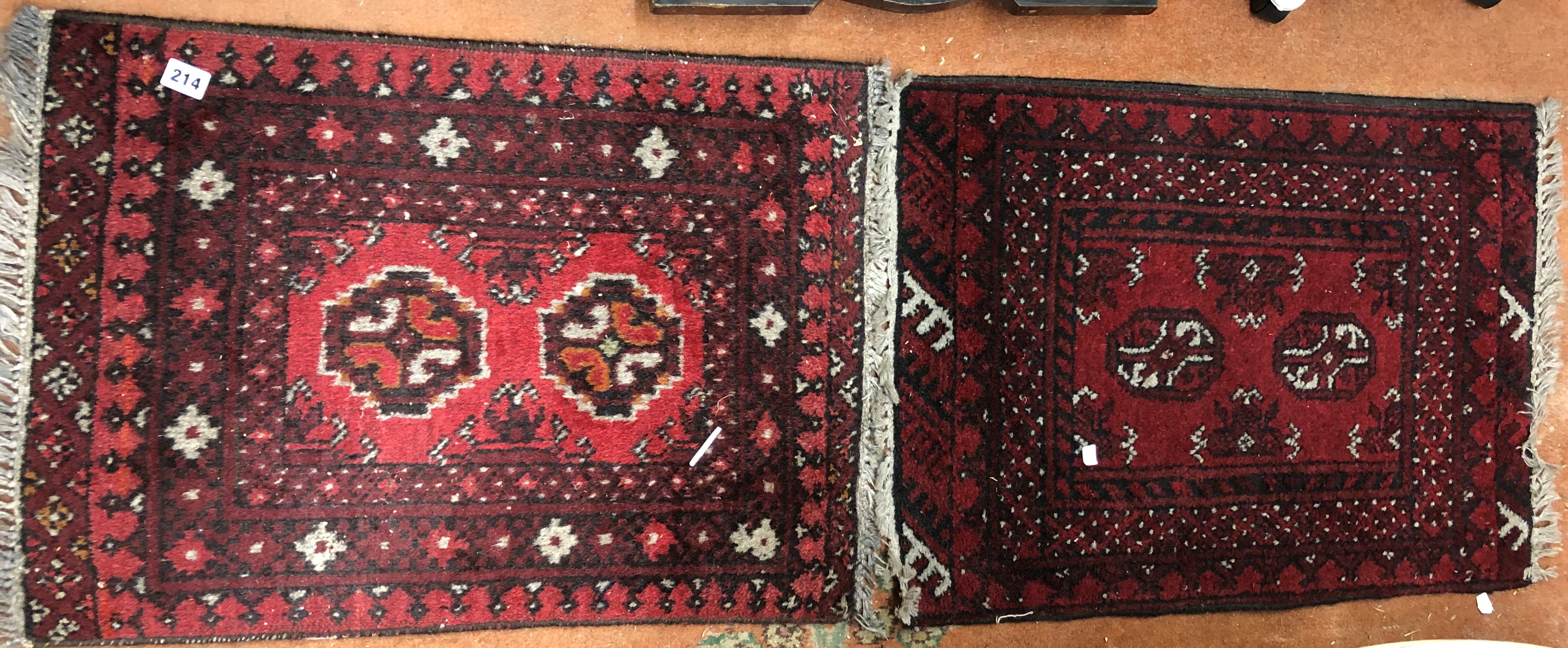 TWO LATE 20TH CENTURY SMALL RUGS ON RED GROUND,