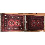 TWO LATE 20TH CENTURY SMALL RUGS ON RED GROUND,