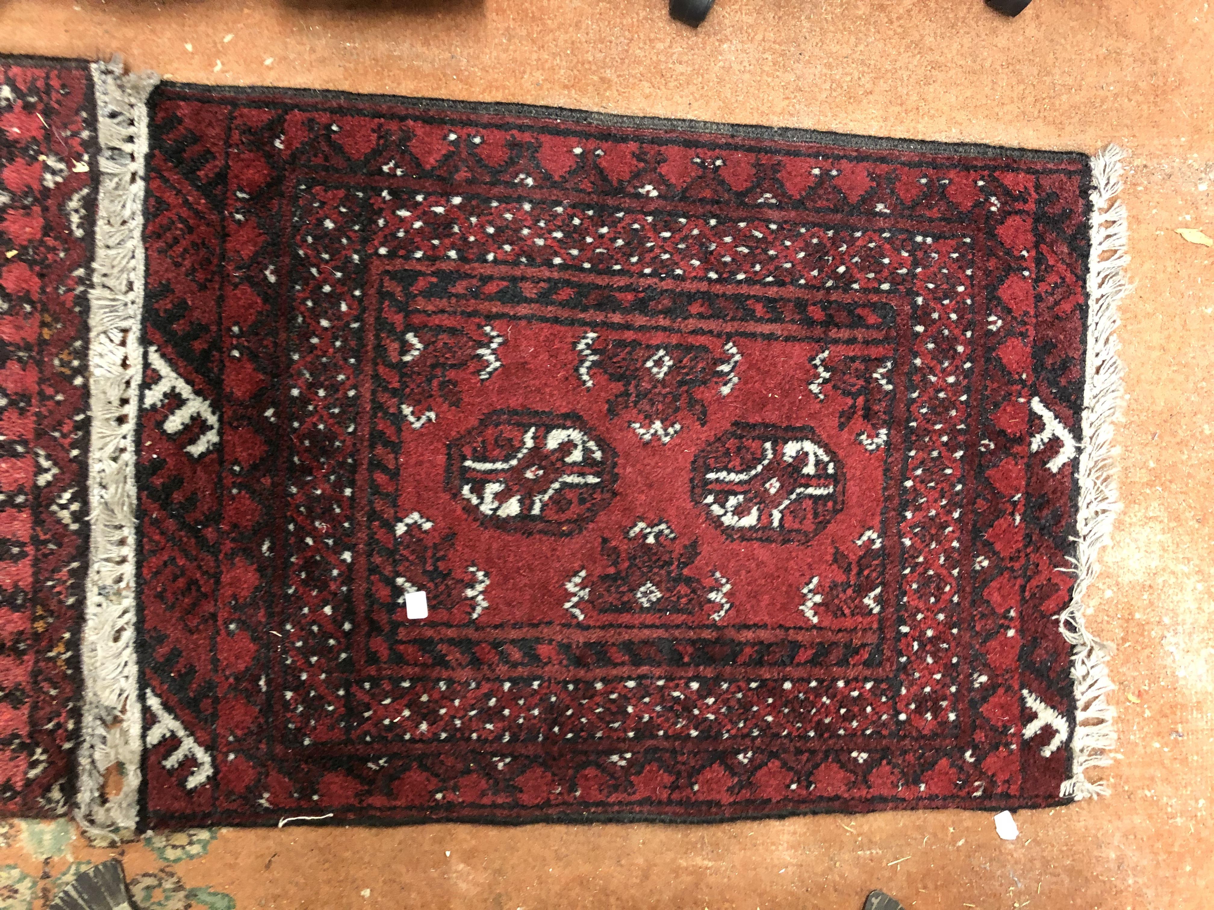 TWO LATE 20TH CENTURY SMALL RUGS ON RED GROUND, - Image 3 of 3