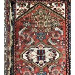 EARLY 20TH CENTURY CAUCASIAN RUG HAVING CENTRAL MEDALLION ON A RED AND BLUE GROUND 83CM X 130CM