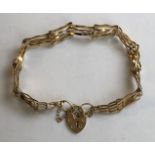 9CT GOLD THREE STRAND BRACELET WITH PART PADLOCK AND SAFETY CHAIN, 4.