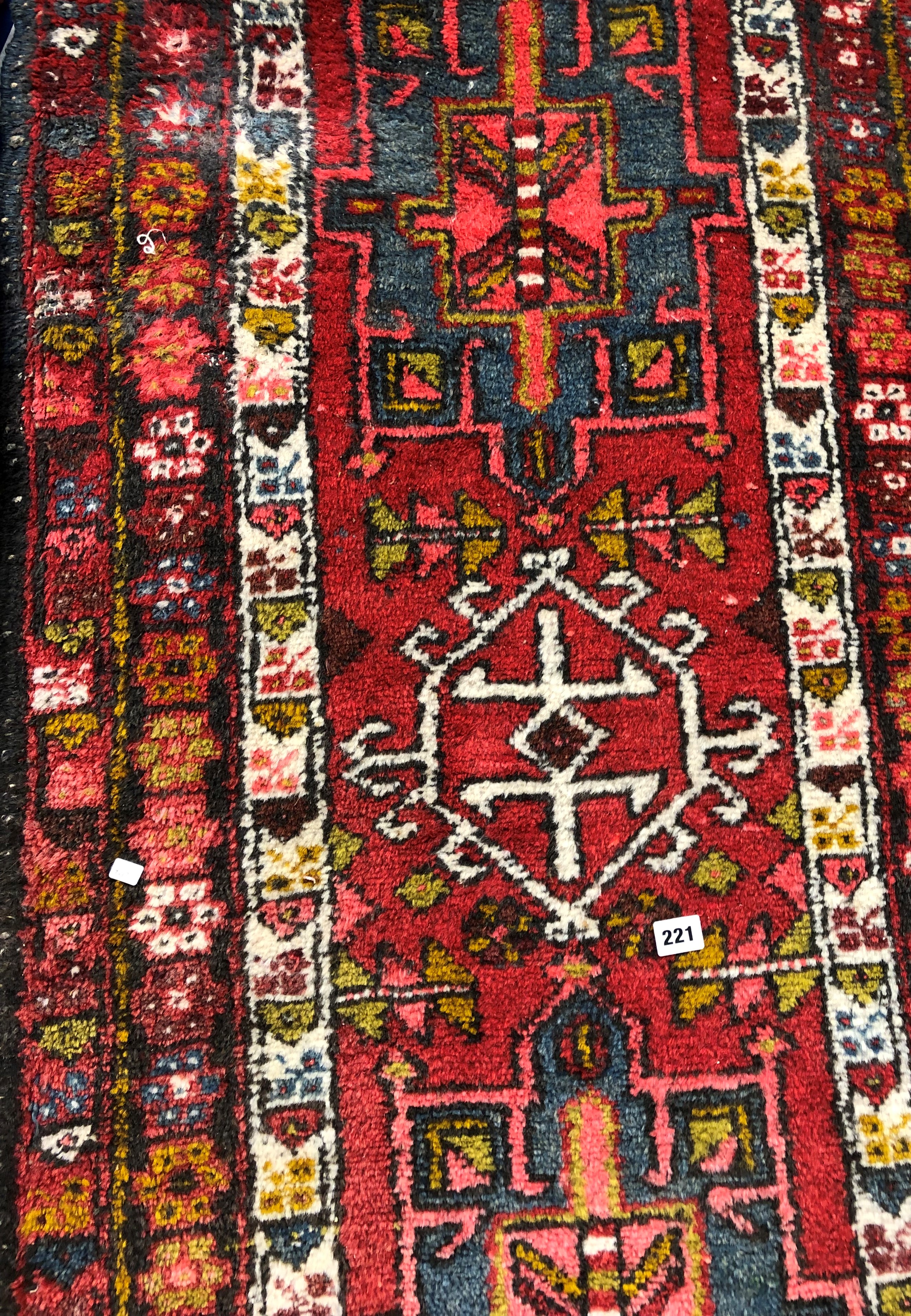 CAUCASIAN RUG ON A RED GROUND 74CM X 300CM APPROX