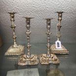 TWO PAIRS OF SHEFFIELD PLATED ROCOCO STYLE CANDLESTICKS