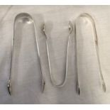 TWO PAIR OF GEORGIAN SILVER SUGAR TONGS, LONDON AND A SMALLER PAIR OF SILVER SUGAR TONGS,