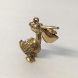 9CT GOLD NOVELTY CHARM OF A STALK WITH RUBY EYES 5.9G APPROX.
