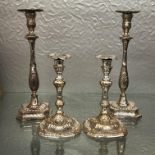 TWO PAIRS OF SHEFFIELD PLATED ROCOCO STYLE CANDLESTICKS