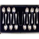 CASED SET OF TWELVE SILVER TEA SPOONS AND SUGAR TONGS WITH BRIGHT CUT DECORATION AND ENGRAVED