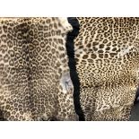 TWO LEOPARD HIDE BACKED SKINS