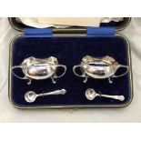 CASED PAIR OF SILVER THREE HANDLES TABLE SALTS WITH SPOONS,