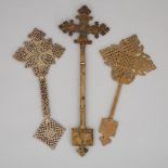 Three Ethiopian Coptic Pierced Bronze Hand Crosses, 19th/early 20th century, length 15 in — 38.1 cm