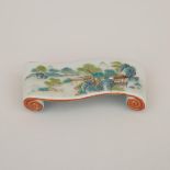 A Famille Rose Scroll-Shaped Inkcake Rest, Qianlong Mark, Qing Dynasty, 清 粉彩山水紋書卷形筆擱/墨床「乾隆年製」四字篆書款,