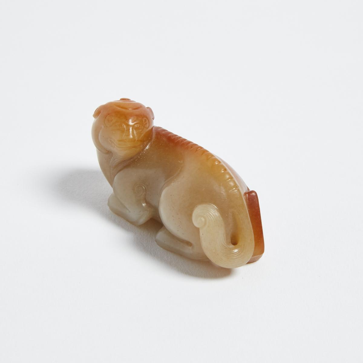 A Pale Celadon and Russet Jade Carving of a Lion, 青白玉帶皮臥獅, length 2.5 in — 6.3 cm - Image 2 of 3