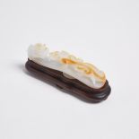 A White and Russet Jade Chilong Belthook, 白玉留皮蒼龍教子帶鉤, length 4.3 in — 11 cm