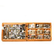 A wooden museum storage box containing two trays of various fossils from the Cretaceous period of