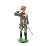 An Elastolin figure of Field Marshal Rommel. Saluting in full grey ceremonial uniform, wearing