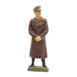 An Elastolin figure of Adolf Hitler. Standing in brown winter great coat with fixed arms. VGC, minor