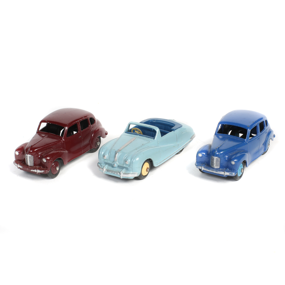 3 Dinky Toys Austin Cars. 2x Devon Saloons (40d/152) in dark blue with mid blue wheels and another